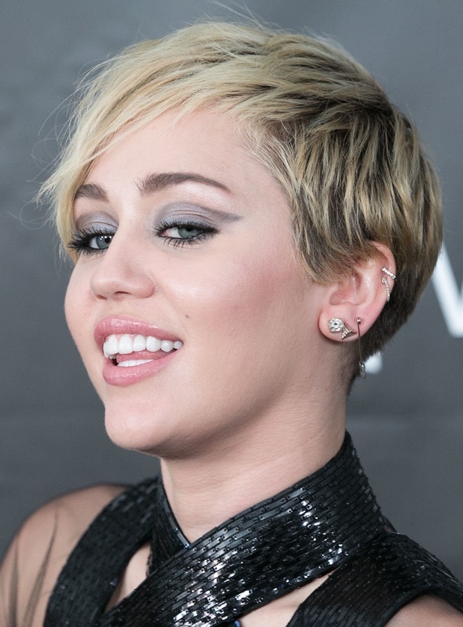 Miley Cyrus wearing simple diamond jewelry with her bondage-inspired dress