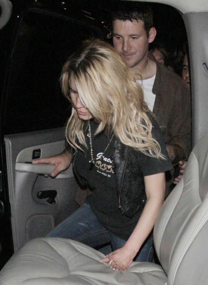 A very tipsy Jessica Simpson is helped into her car by boyfriend Tony Romo after seeing '80s metal/hard rock tribute band Metal Skool perform at the Key club on the Sunset Strip