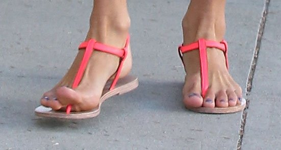 Alessandra Ambrosio flaunts her perfectly pedicured feet in chic neon T-strap sandals