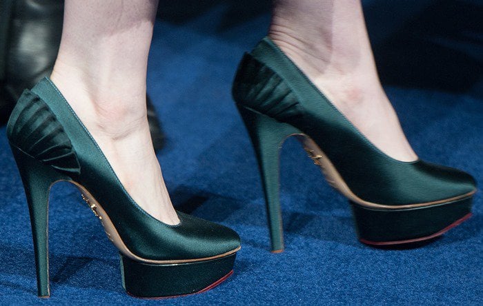 Anne Hathaway shows off her feet in Charlotte Olympia "Paloma" platform pumps in green satin