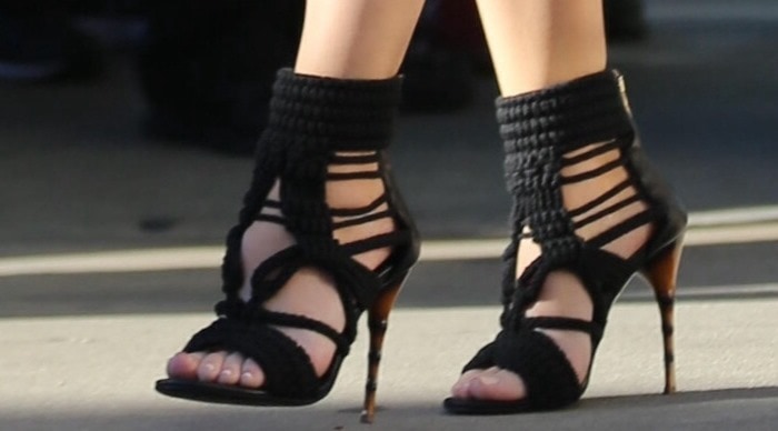 Khloé Kardashian's Balmain heels are a stunning choice, featuring intricately woven braided ropes and bamboo-effect stiletto heels