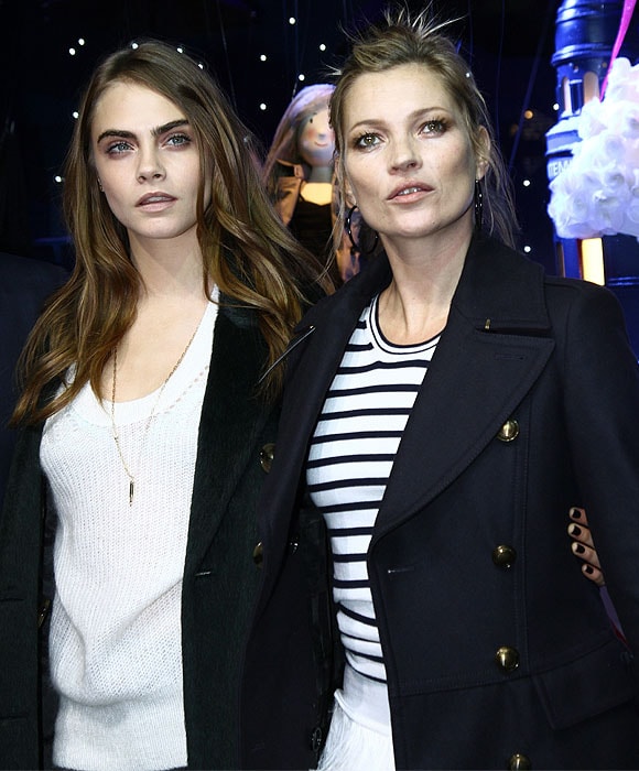 Cara Delevingne and Kate Moss posing together at the unveiling of the Burberry festive window display at Printemps in Paris