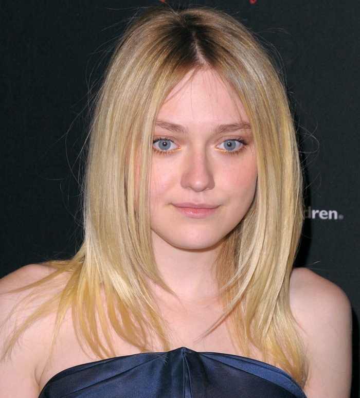 Dakota Fanning keeps it elegant in a midnight blue strapless dress, highlighting her natural beauty at the Save the Children Illumination Gala