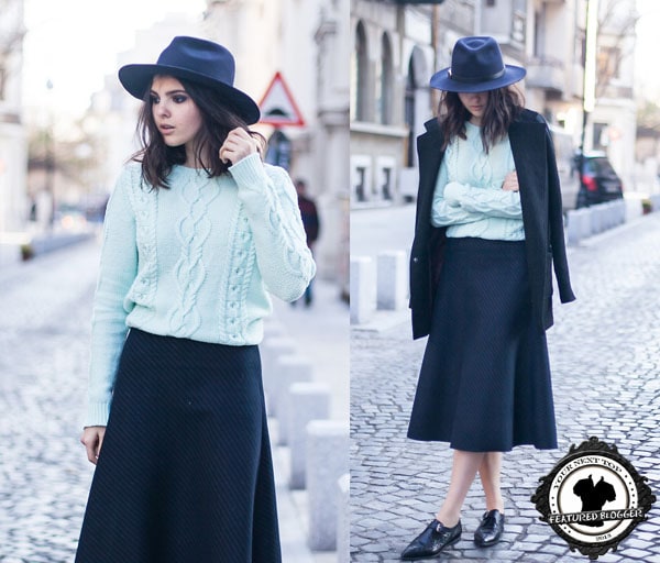 Doina wore a fedora with a sweater, an A-line skirt, and leather shoes