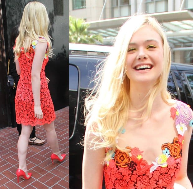 Elle Fanning radiates joy in a red lace dress with floral appliqués at San Diego Comic-Con