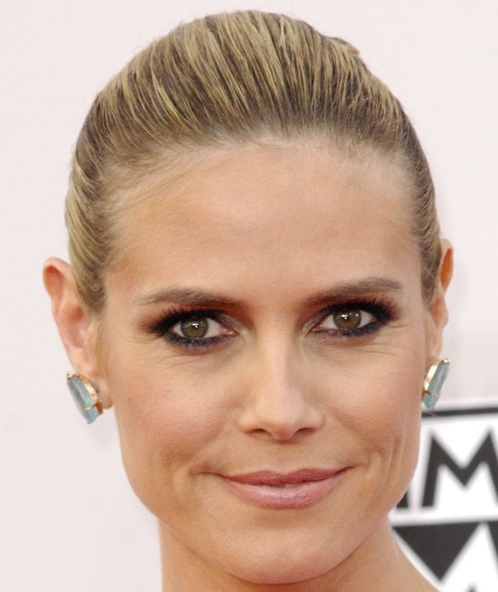 Heidi Klum at the 2014 American Music Awards, showcasing a sleek updo and minimalistic jewelry