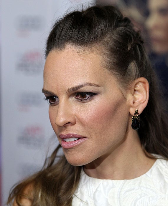 Hilary Swank sporting a half-braided hairdo and black drop earrings from Neil Lane jewelry