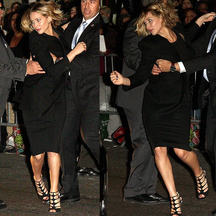 Jennifer Lawrence struggling with her bodyguard to get back to her car after signing autographs