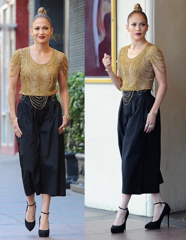 Jennifer Lopez dazzles at the Hollywood week auditions in high-waisted pleated gaucho pants by Alice + Olivia, paired with a Naeem Khan gold chain top and Giuseppe Zanotti suede platform pumps, adding a spectacular touch to her ensemble