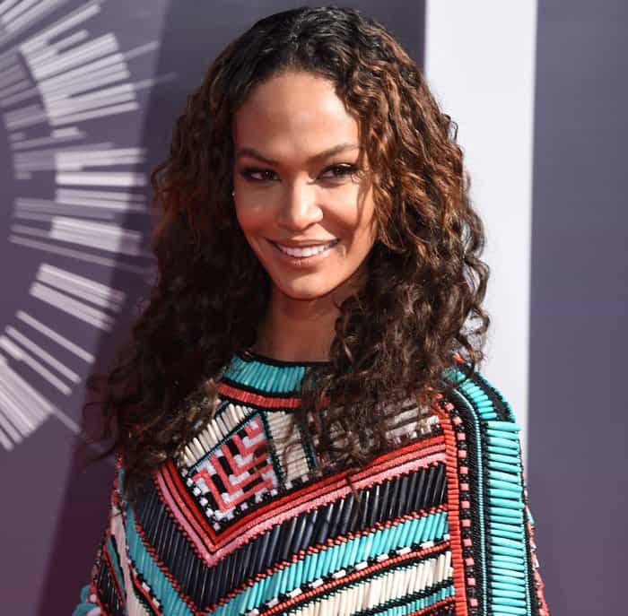 Joan Smalls exuded confidence with her natural curls and glowing makeup, perfectly complementing her colorful beaded Balmain mini dress at the 2014 MTV Video Music Awards