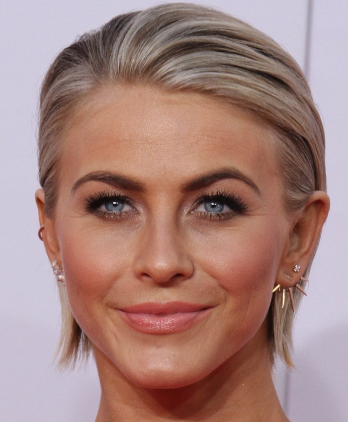 Julianne Hough showcases a sleek, pulled-back hairstyle paired with elegant spike earrings
