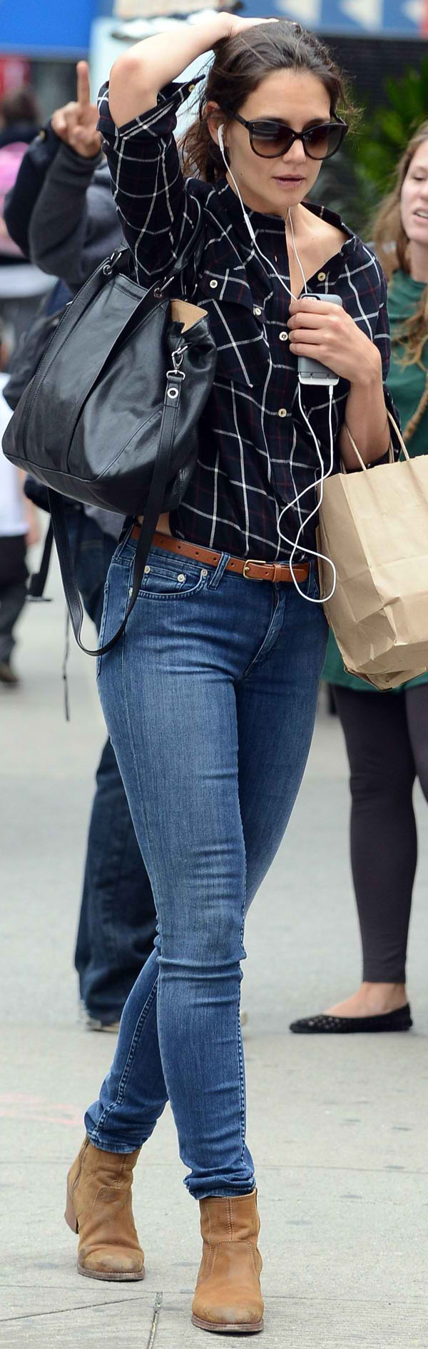 Katie Holmes in New York listening to music while shopping on September 27, 2013