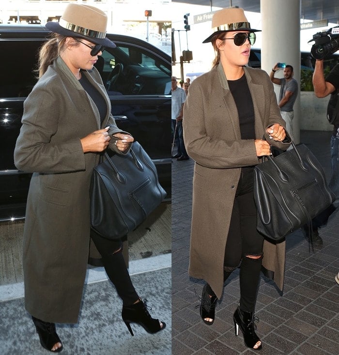 Khloe Kardashian totes a Celine tote while departing from Los Angeles International Airport (LAX) in ripped denim jeans