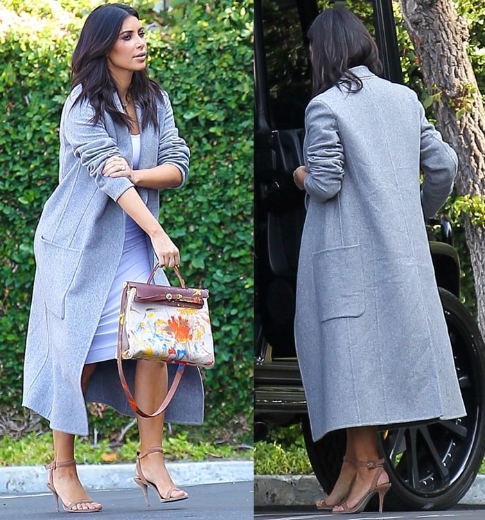 Kim Kardashian sported a tight white dress paired with a gray Celine coat