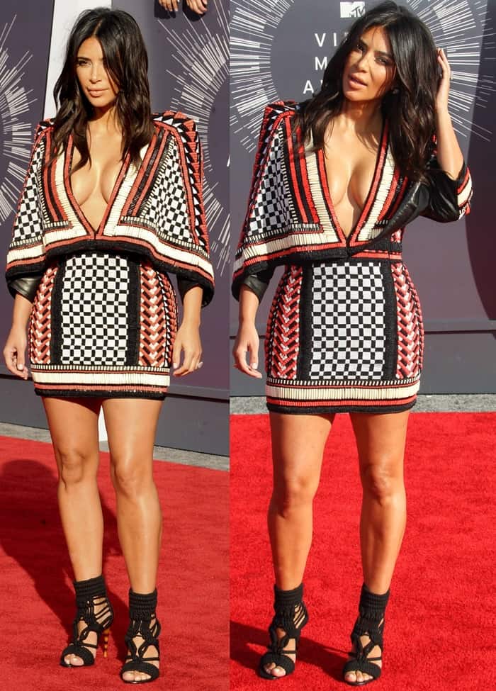 Kim Kardashian turned heads at the 2014 MTV Video Music Awards in a plunging red and black Balmain mini dress, styled with black braided-rope sandals and her signature voluminous waves
