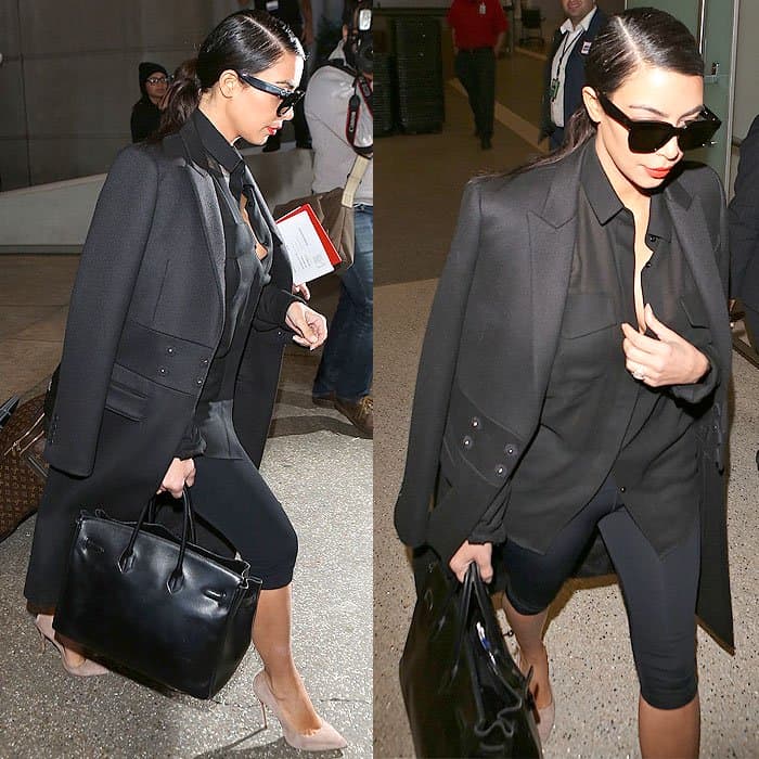 Kim Kardashian at LAX arriving from Dubai, wearing cropped leggings, a tailored coat, dark oversized sunglasses, a black top, and nude-colored shoes