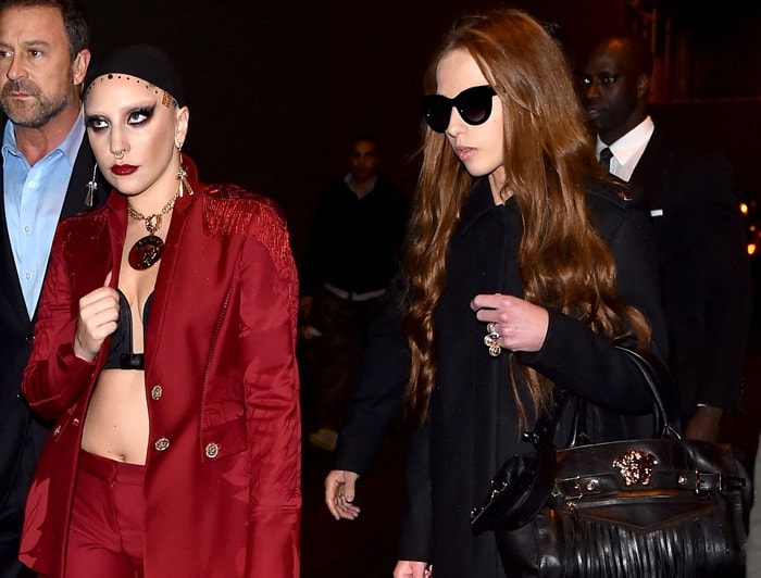 Lady Gaga rocking red pants paired with a matching unbuttoned blazer that left her black bra exposed