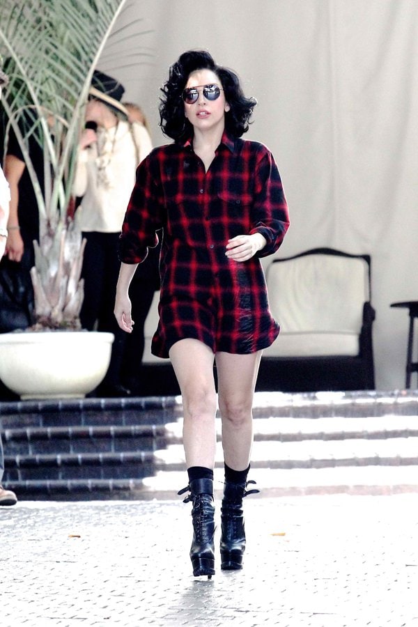 Lady Gaga wearing a plaid shirt while leaving her hotel