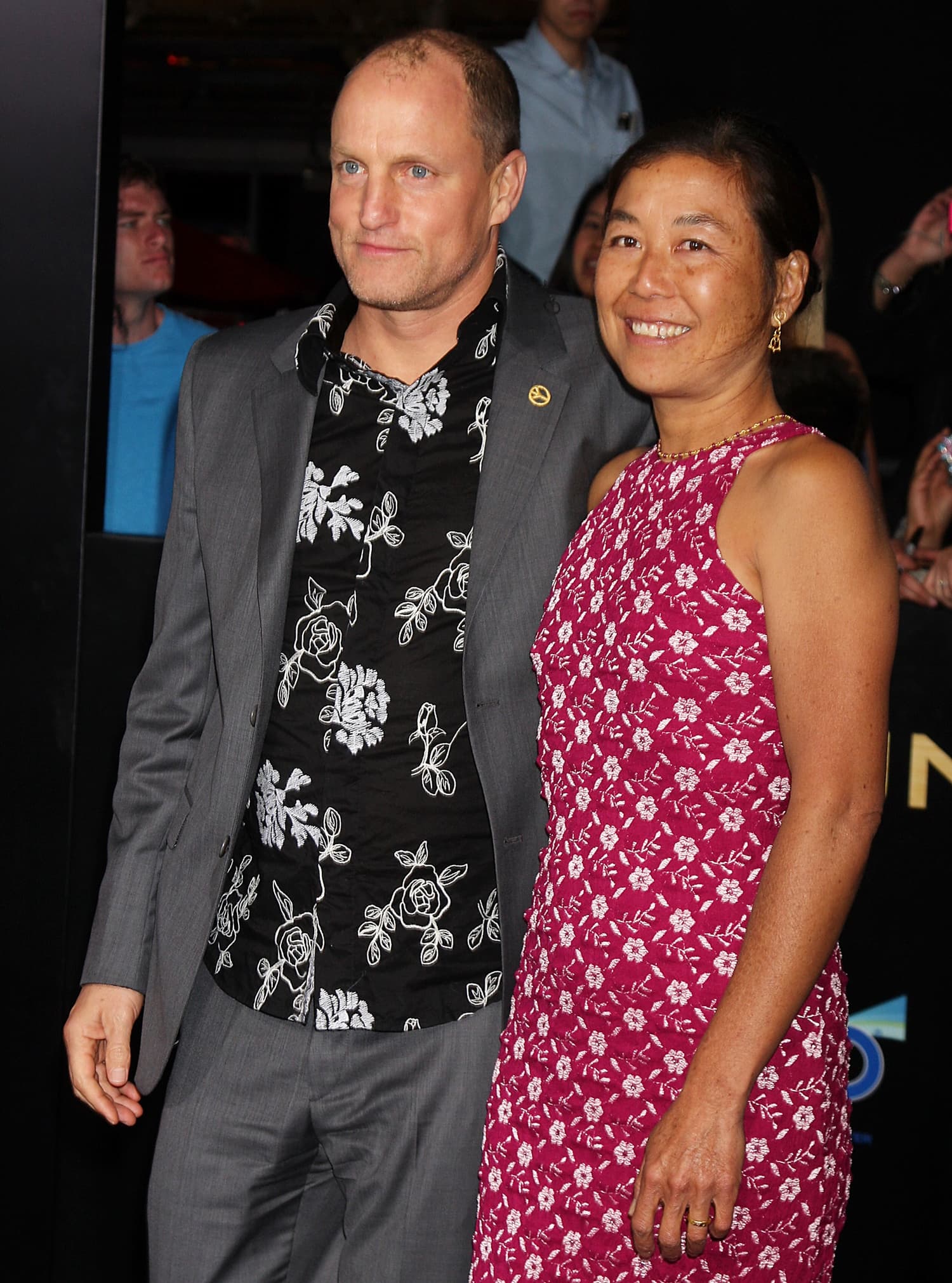 Pictured with his wife Laura Louie, self-proclaimed butthole Woody Harrelson says he did his best to make Jennifer Lawrence laugh while filming Hunger Games