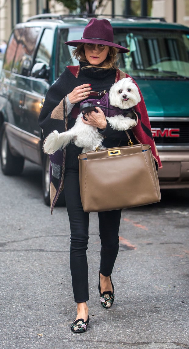 Olivia Palermo looking stylish wearing a hat and a Burberry color block check blanket poncho, running errands in Brooklyn on October 21, 2014