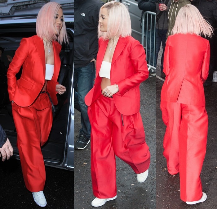 Rita Ora wearing a red silk blazer and matching pants at Sarm Studios