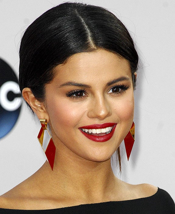 Selena Gomez wearing gold geometric earrings from Neil Lane jewelry