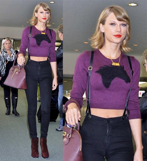 Taylor Swift in trousers with suspenders, purple cropped jumper, and red ankle boots at Narita International Airport on November 8, 2014