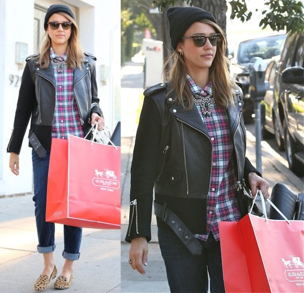 Jessica Alba wears a beanie with cheetah print flats and a leather jacket