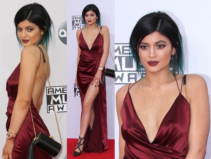 Kylie Jenner flashing her legs in a wine-red low-cut silk gown