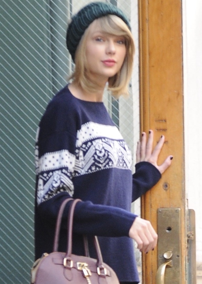 Taylor Swift wearing a beanie from Topshop while leaving her apartment