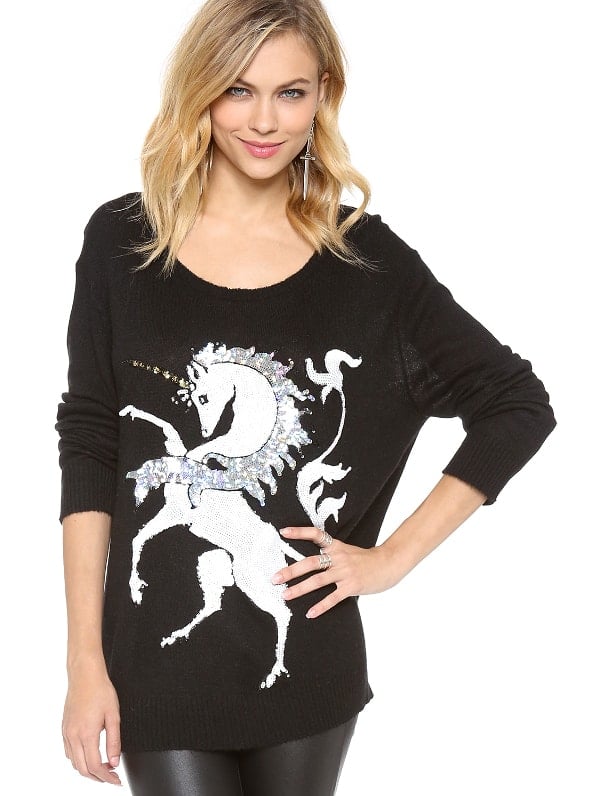 Brilliant sequins detail a galloping unicorn on a soft fine knit sweater