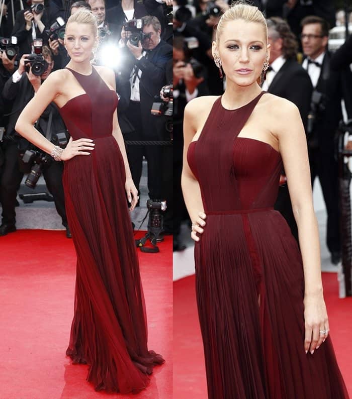 Blake Lively wows once again at the 67th Cannes Film Festival, wearing a stunning oxblood chiffon dress with a thigh-high slit and open-back detail by Gucci, paired with ruby-and-diamond Lorraine Schwartz statement earrings