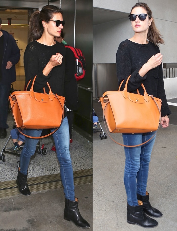 Alessandra Ambrosio in skintight jeans paired with a baggy black sweater and wedge ankle boots
