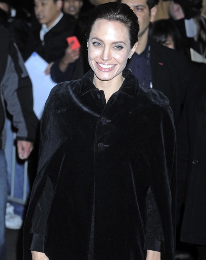 Angelina Jolie in a black cotton velvet cape from Saint Laurent featuring a classic collar