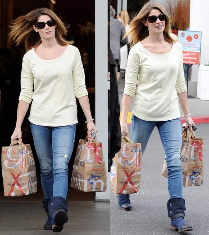 Ashley Greene styled distressed jeans with a patterned sweatshirt