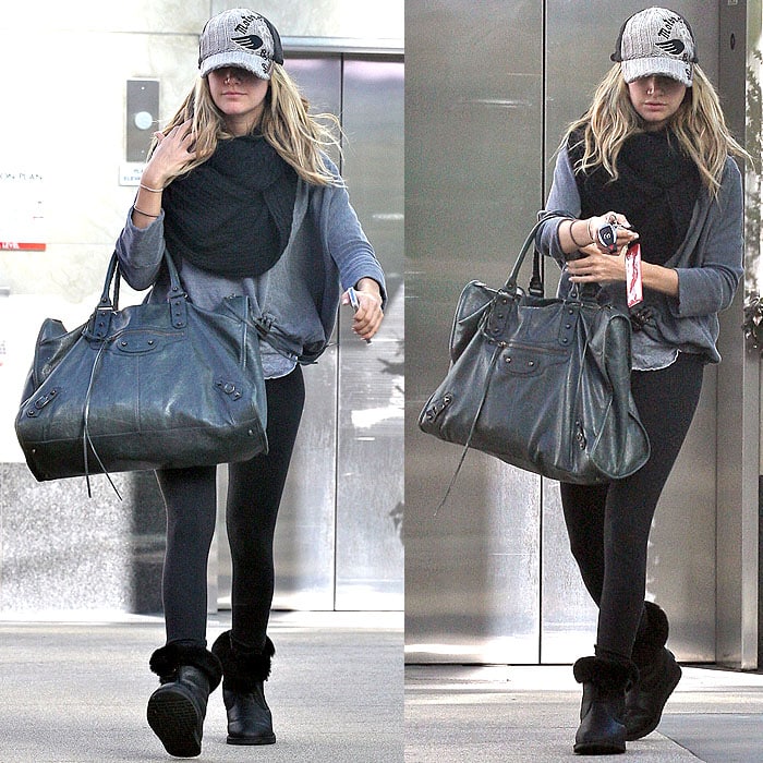 Ashley Tisdale elevates a casual look of leggings, Ugg boots, and a T-shirt with a chic designer handbag while heading to the gym in West Hollywood on January 24, 2012