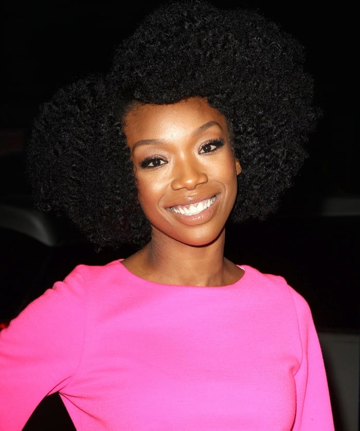 Brandy Norwood styled her look with a vibrant pink top and natural afro hairstyle at the 'Haunted House 2' premiere