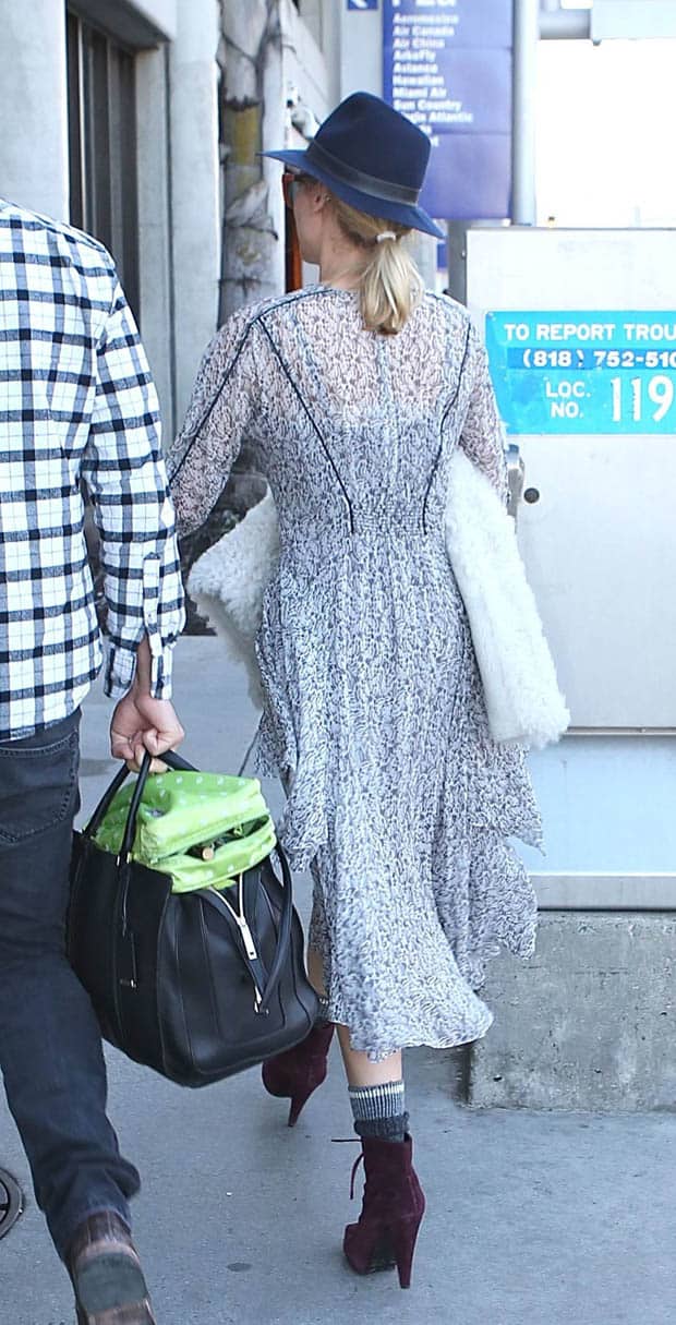Diane Kruger masterfully layers a boho midi dress with a fur jacket and fedora for a chic winter look