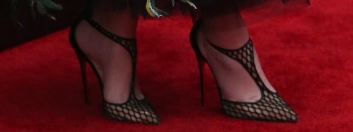 Emily Blunt shows off her feet in fishnet pumps