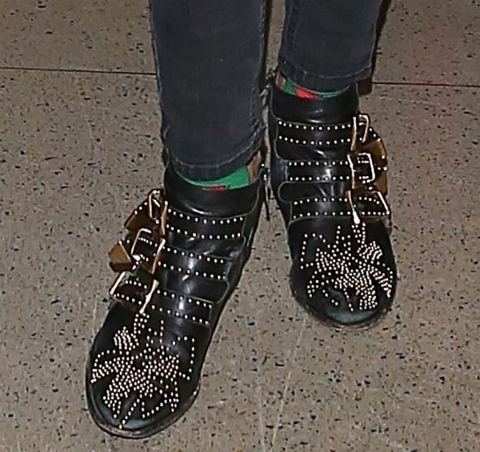 Emma Roberts wearing green socks and Chloe boots