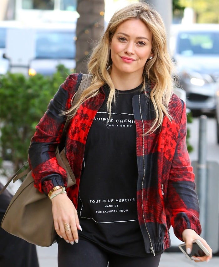 Hilary Duff spotted wearing a french sweatshirt with the logo "Soirée Chemillé party shirt, Tout Neuf Mercier, Made by the Laundry Company" after leaving a nail salon in Beverly Hills on December 17, 2014