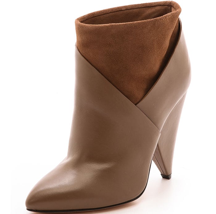 The toe tapers to a structured point, and a wide cone heel elevates the silhouette