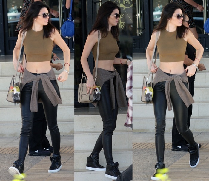 Kendall Jenner flashes her toned midriff in an olive crop top by Sorella