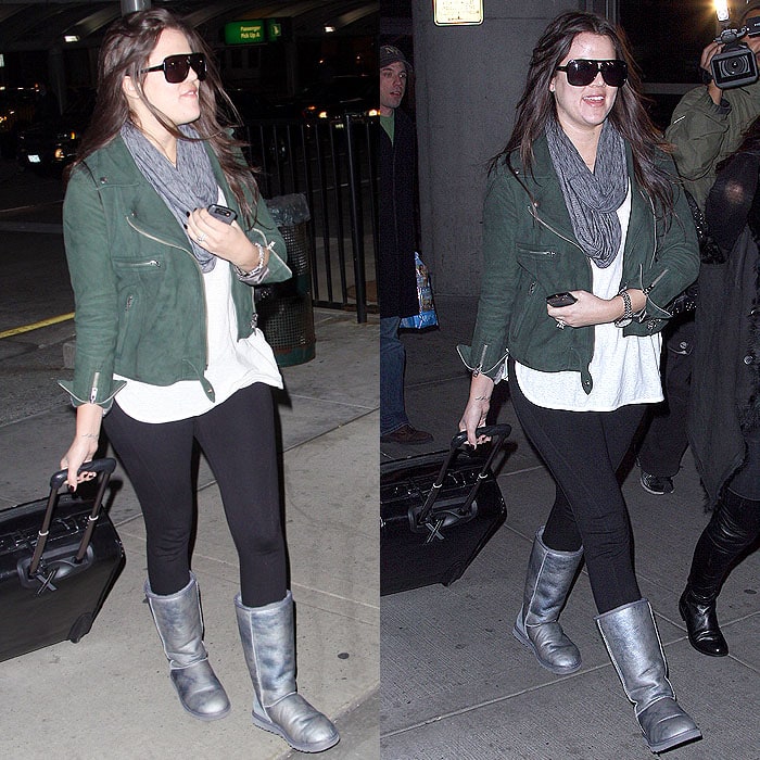 Khloé Kardashian keeps it chic and laid-back in leggings, Ugg boots, and a long t-shirt topped with a cropped biker jacket while traveling through JFK Airport on December 7, 2009