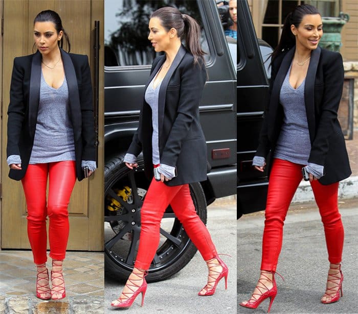 Kim Kardashian turns heads with red leather pants, a grey sweater, and red strappy Azzedine Alaïa lace-up sandals in Calabasas.