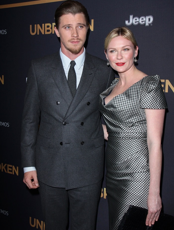 Kirsten Dunst stuns in a vintage-inspired gingham-print Vivienne Westwood dress, paired with a black clutch, as she accompanies Garrett Hedlund at the Unbroken premiere