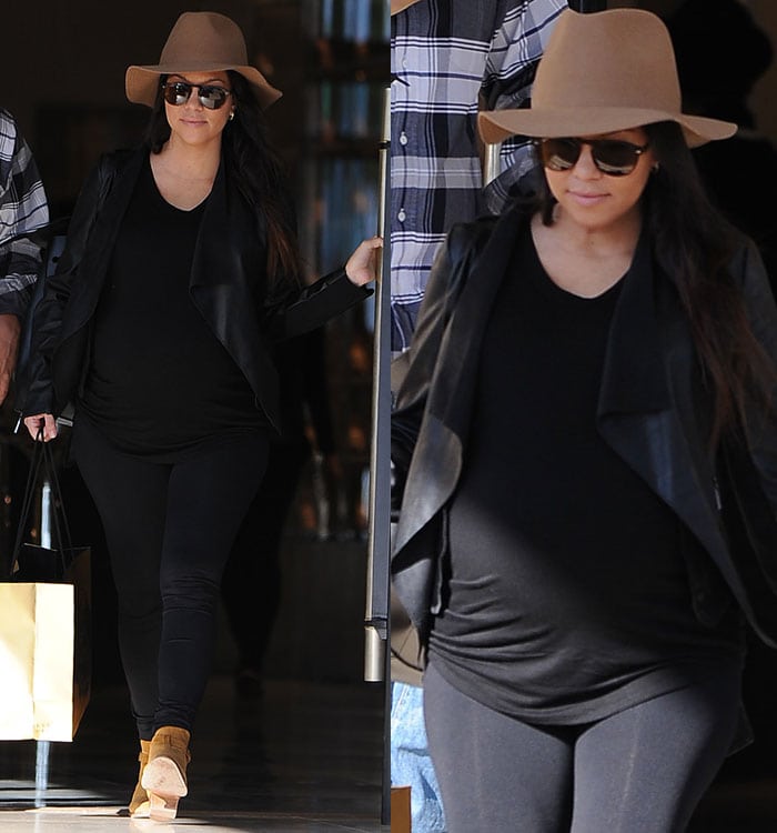Kourtney Kardashian wears a hat over her hair as she goes shopping