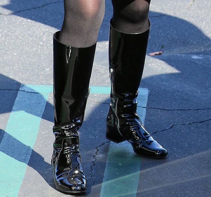 Kris Jenner wearing Saint Laurent patent knee-high boots