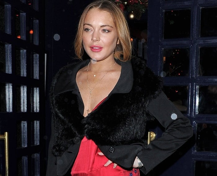 Lindsay Lohan sported a red star-embroidered lace and satin jumpsuit by Matthew Williamson paired with a black furry Marin jacket