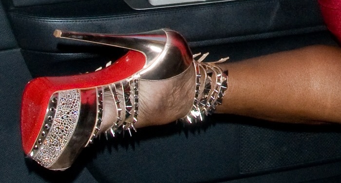 NeNe Leakes showcases the intricate details of Christian Louboutin 'Isolde' sandals, featuring spiked embellishments, metallic accents, and signature red soles